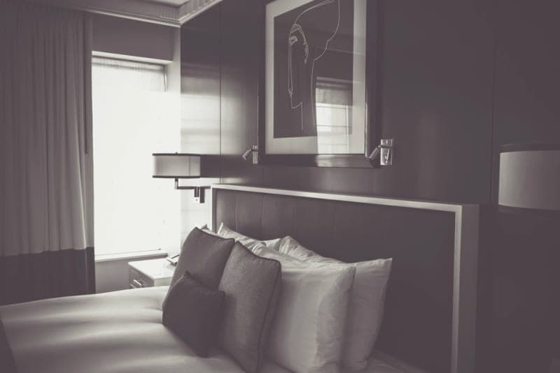 Two pillows side by side on a dark bed